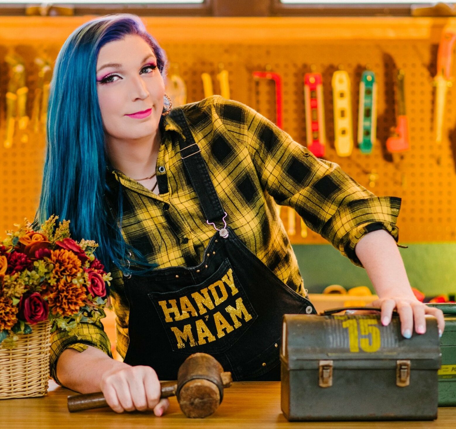 A photo of influencer Mercury Stardust in a tool shop.