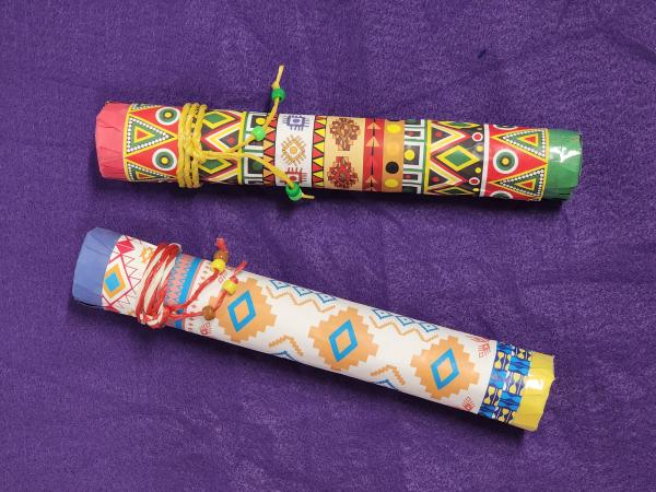 two decorated rainsticks made by children