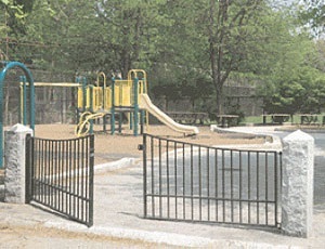 a photograph of a gate in front of a playground