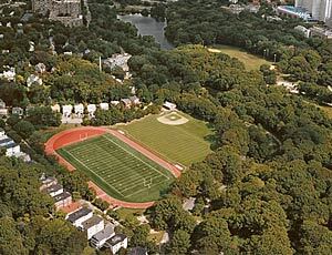 An aerial view of a football field, track, and baseball field